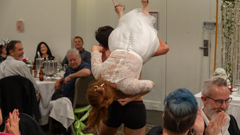 Bride being carried in a fireman's lift